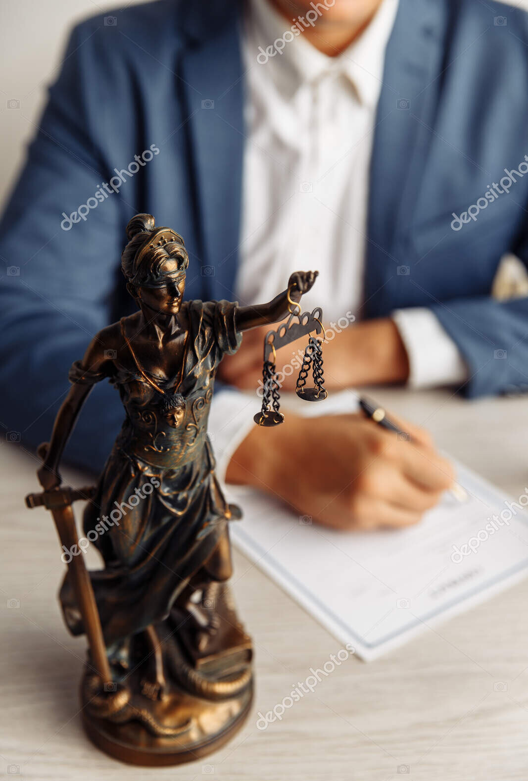 lawyer office. statue of justice with scales and lawyer sighning a document. legal law, advice and justice concept