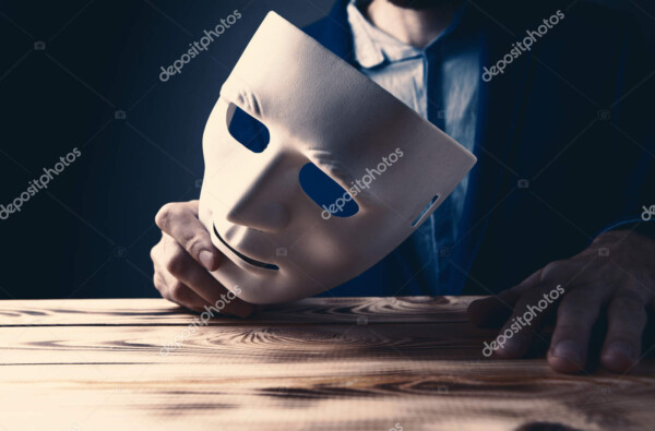businessman holding white mask in his hand